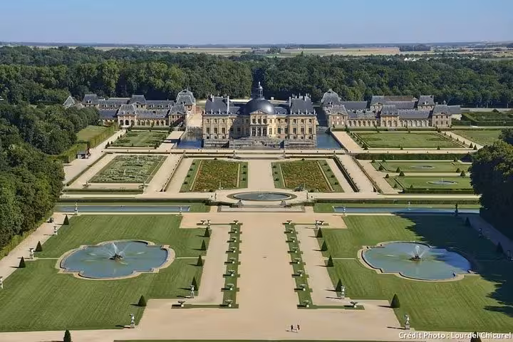 Aerial view of Vaux le Vicomte château with formal French gardens, fountains, and manicured hedgerows near Paris