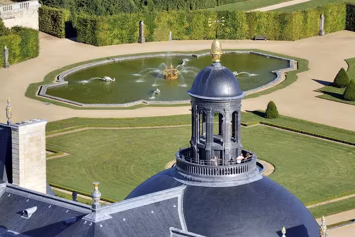 Aerial view of Vaux-le-Vicomte château dome and ornate fountain garden with sculpted hedges