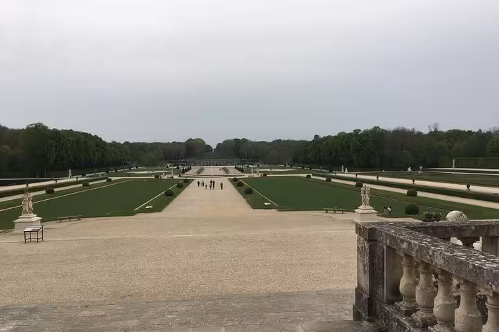 Formal French garden at Vaux le Vicomte with symmetrical lawns, gravel paths, and sculpted hedges