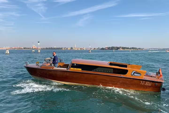 Private wooden Venetian water taxi cruising the lagoon, Grand Canal boat tour with Murano and Burano stops
