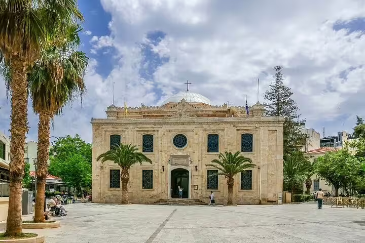 Historic Venetian church in Heraklion Town, Crete, surrounded by palm trees, ideal for Knossos Palace private tours.