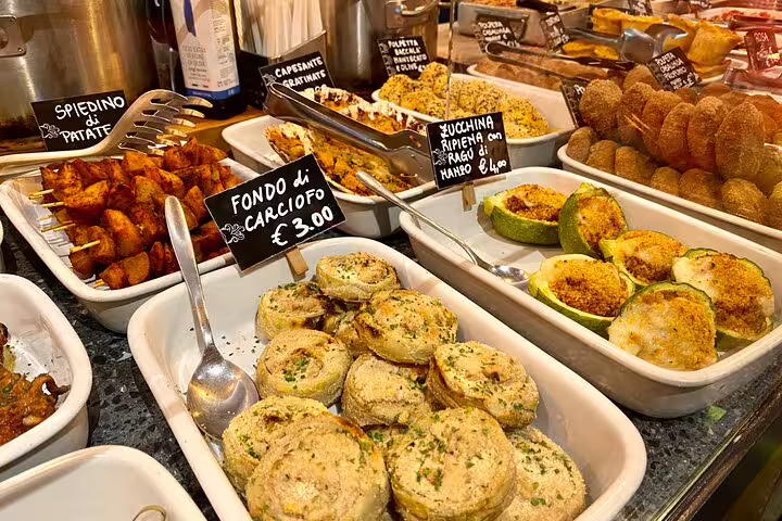 Authentic Venetian cicchetti spread featuring stuffed zucchini artichoke hearts and potato skewers at a local Venice market