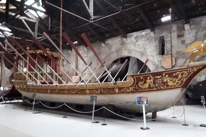 Historic Venetian galley displayed in a museum, showcasing Venice's maritime heritage on deluxe tour.