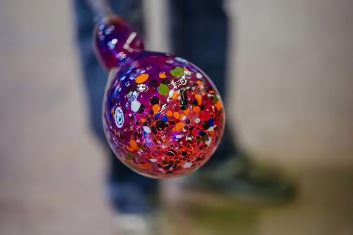 Close-up of vibrant, multicolored Venetian glass art during a Murano glassblowing demonstration in Venice tour.