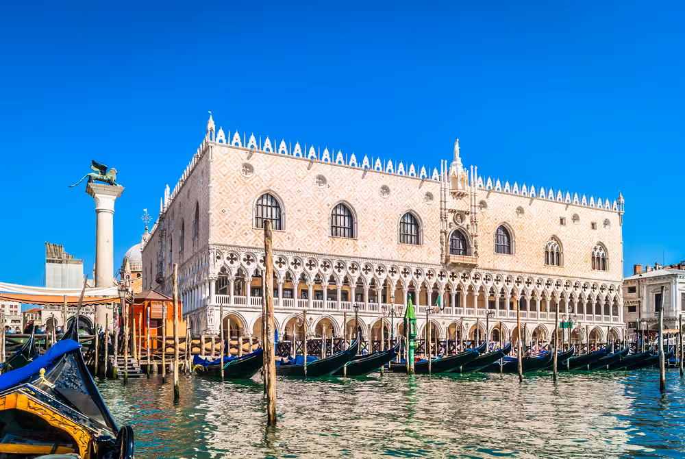Venetian gondolas moored near the majestic Doge's Palace, capturing the essence of Venice's historic charm.
