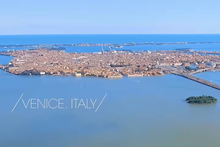 Aerial view of Venice, Italy with iconic canals and architecture, ideal for private transfers from the airport.
