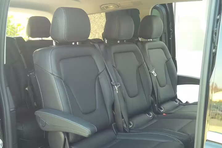 Spacious black leather interior of a van for private transfer from Venice Marco Polo airport to Piazzale Roma.