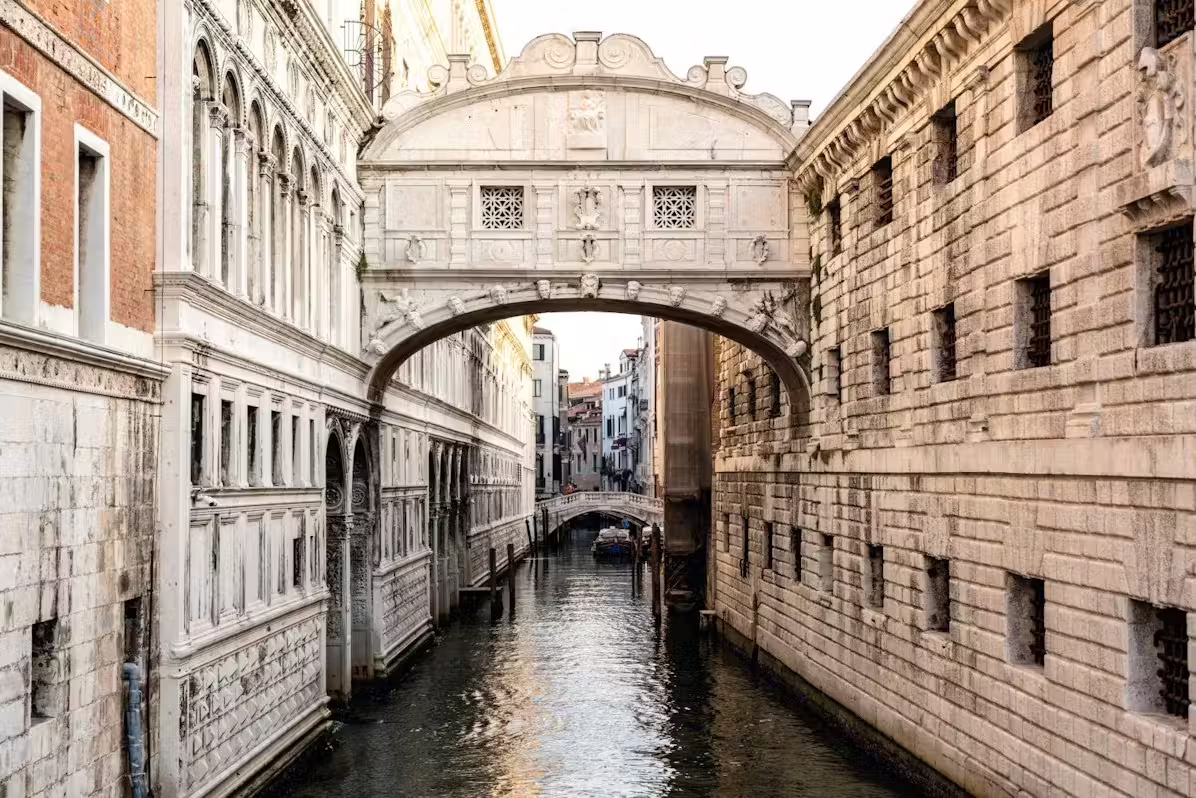 View of Venice’s Bridge of Sighs over a quiet canal included on a private Venice highlights tour with skip-the-line St. Mark’s Bell Tower