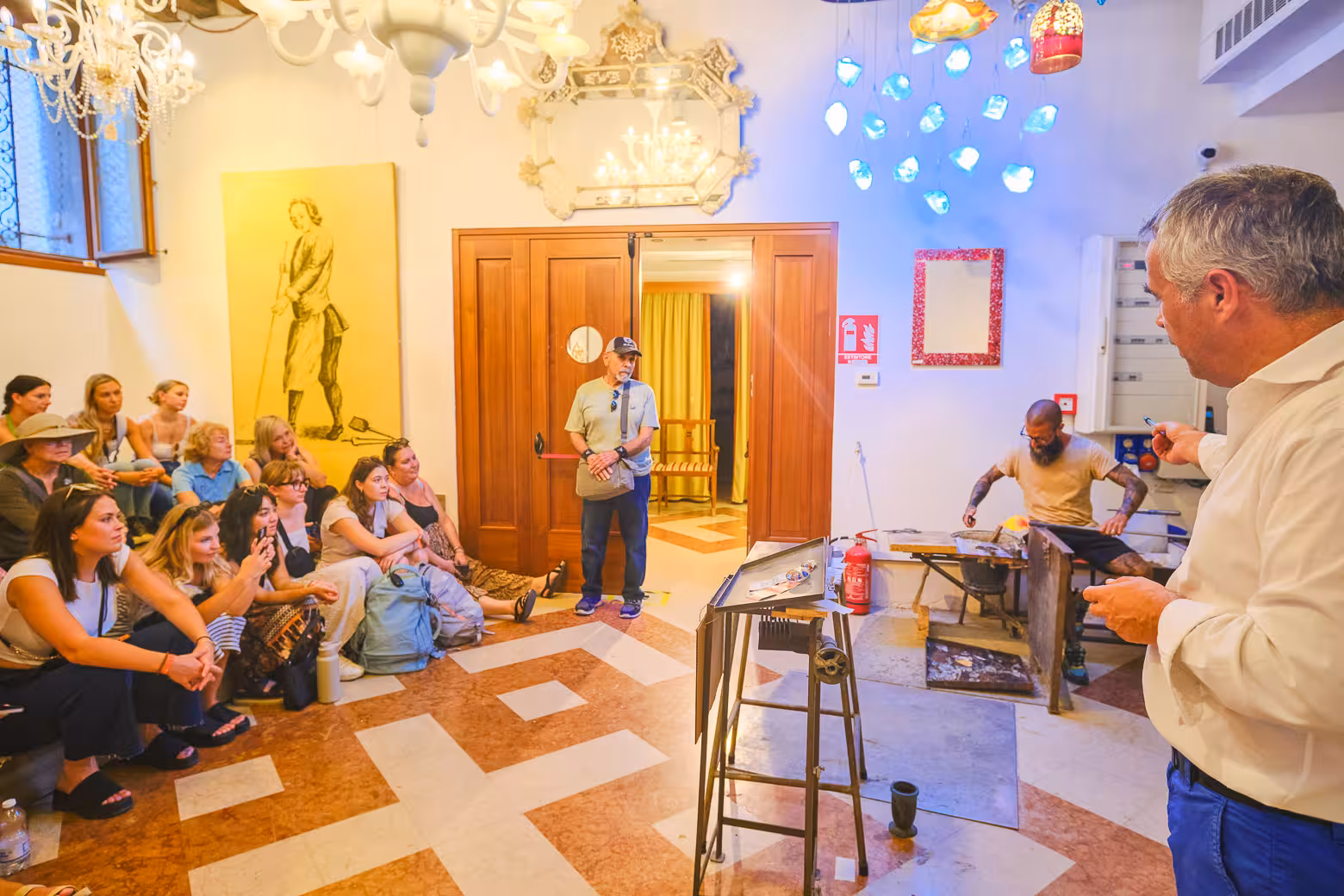 Visitors watch a captivating glassblowing demonstration in Venice, showcasing the city's renowned artisan craftsmanship.