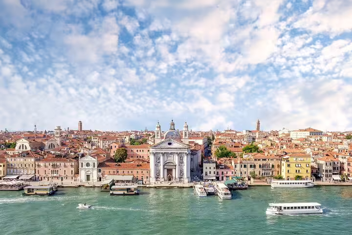 Panoramic view of Venice waterfront and historic basilica from the Grand Canal on a last minute private city tour by boat