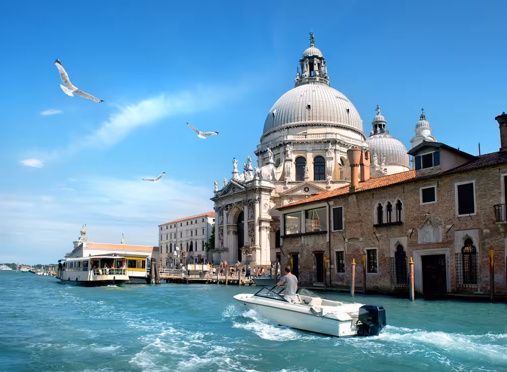 Venice Grand Canal view with motorboat near Doge's Palace, ideal for Inside Venice combo tour experience.