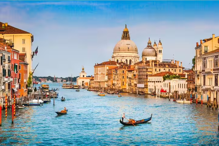 Grand Canal Venice with gondolas and Santa Maria della Salute basilica on a sunny day