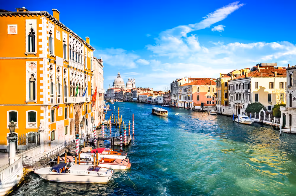 Scenic view of Venice's Grand Canal with vibrant buildings, ideal for exploring on a walking tour.