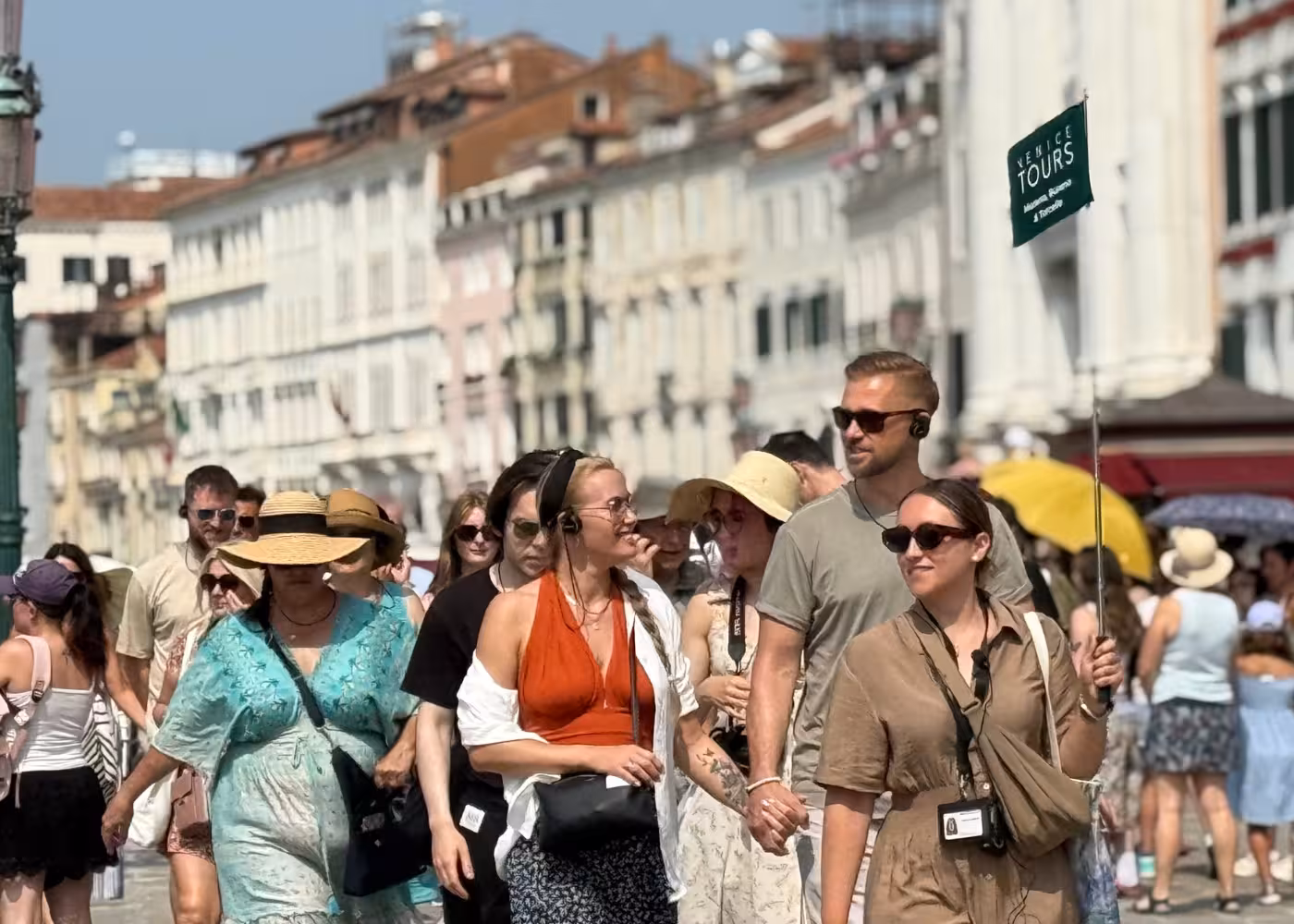 Tour group exploring Venice with a guide, experiencing the vibrant atmosphere of the Grand Tour's itinerary.