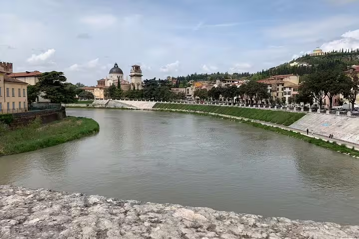 Serene river view with historic architecture along the scenic Venice to Milano private transfer route.