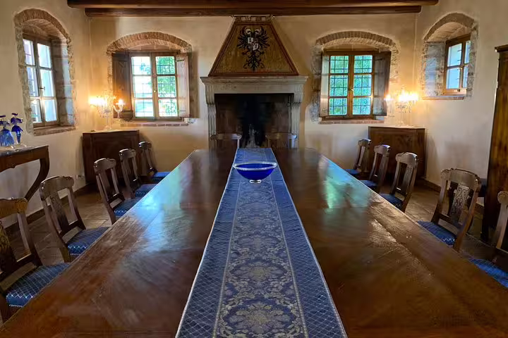 Elegant dining room with a long wooden table and classic decor for a refined transfer experience from Venice to Milano.