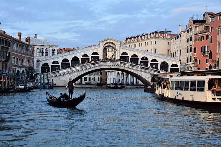 Explore Venice's iconic Rialto Bridge and bustling Grand Canal on the Venice Express Walking Tour.