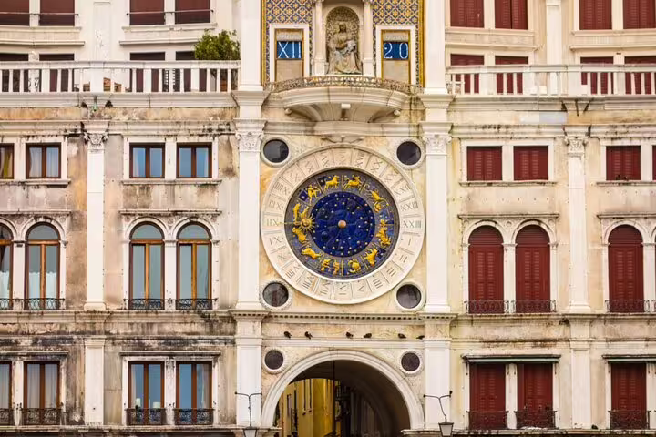 St Mark's Clock Tower with zodiac clock face and arch in Venice, Italy