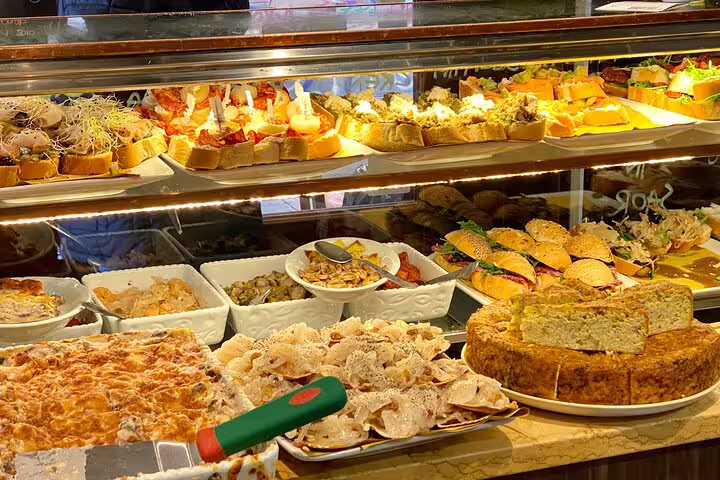 Vibrant Venice street food market display with cicchetti sandwiches fresh salads and savory baked dishes on a walking tour