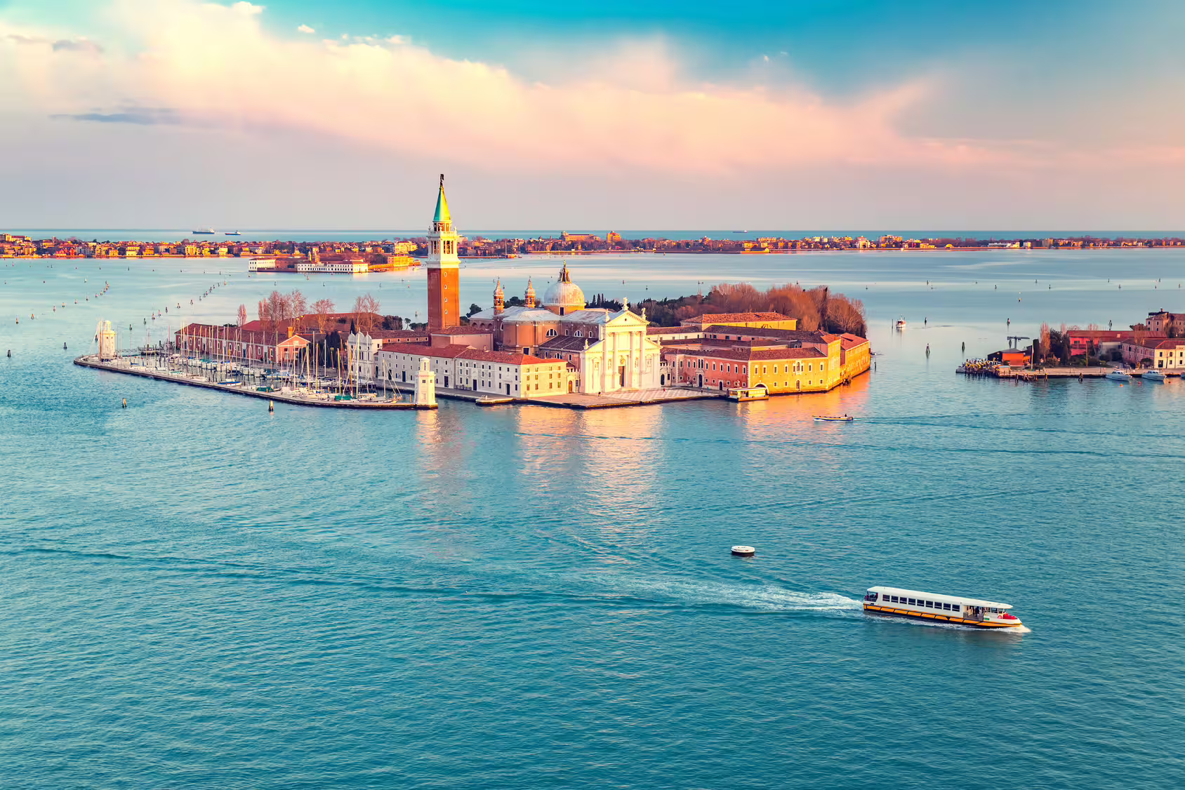 Sunset view of San Giorgio Maggiore island and Venetian lagoon seen on a private Venice boat tour with bell tower tickets