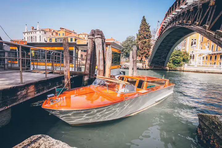 Elegant water taxi docked in Venice, ready for a private transfer to Chioggia Port, showcasing classic Italian design.