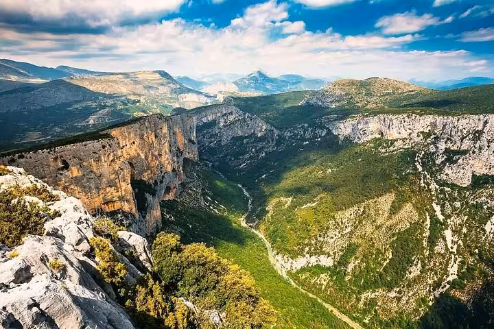 Aerial view of Verdon Gorge with turquoise river winding through dramatic limestone cliffs and green valleys