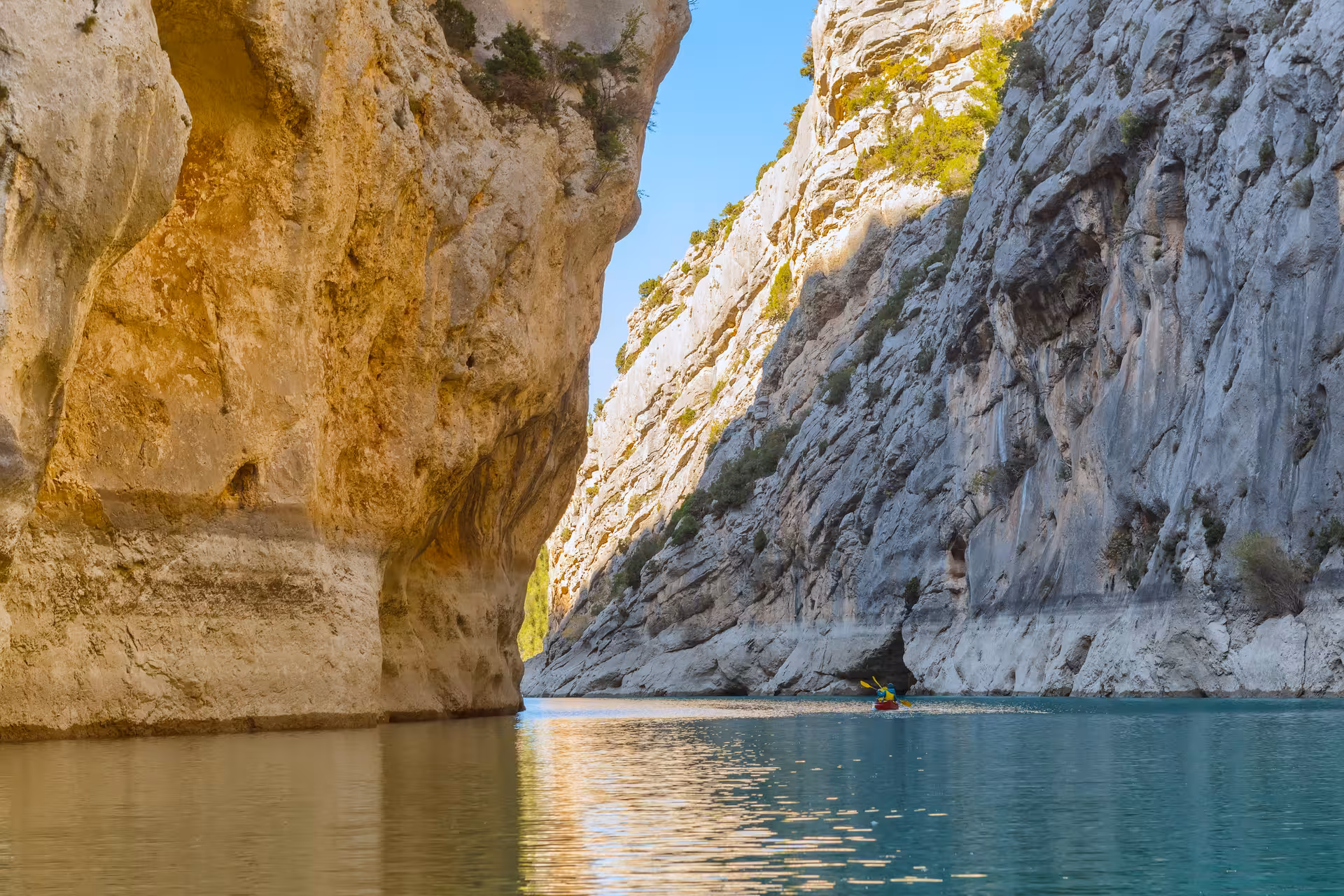 Solo kayaker glides through towering limestone cliffs of Verdon Gorge on a 6D/5N lodge river adventure