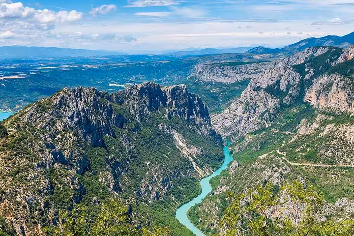Aerial view of turquoise Verdon River winding through dramatic limestone gorge canyon in Provence, France