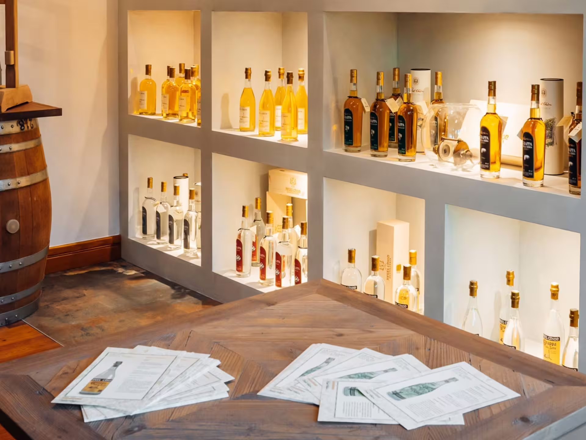 Elegant display of spirits in a Turin distillery, highlighting the rich selection available for tasting tours.