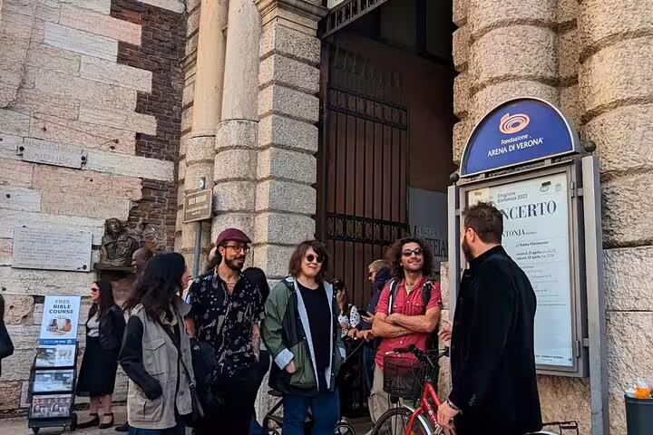 Small group meets guide outside Verona Arena for 1.5-hour food tour with tastings and sightseeing