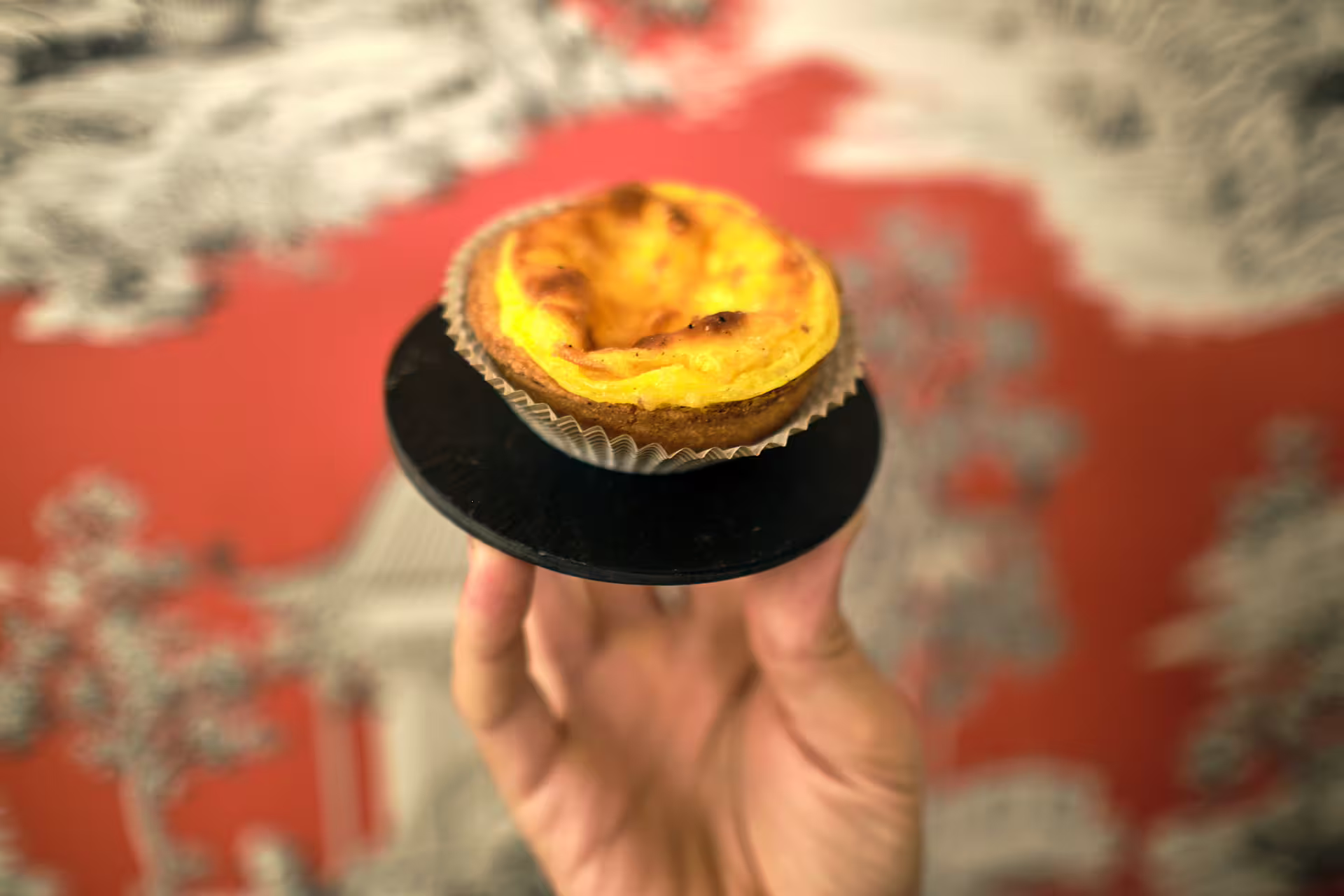 Hand holding a warm Italian custard tart tasting during a 1.5 hour Verona food tour with sightseeing