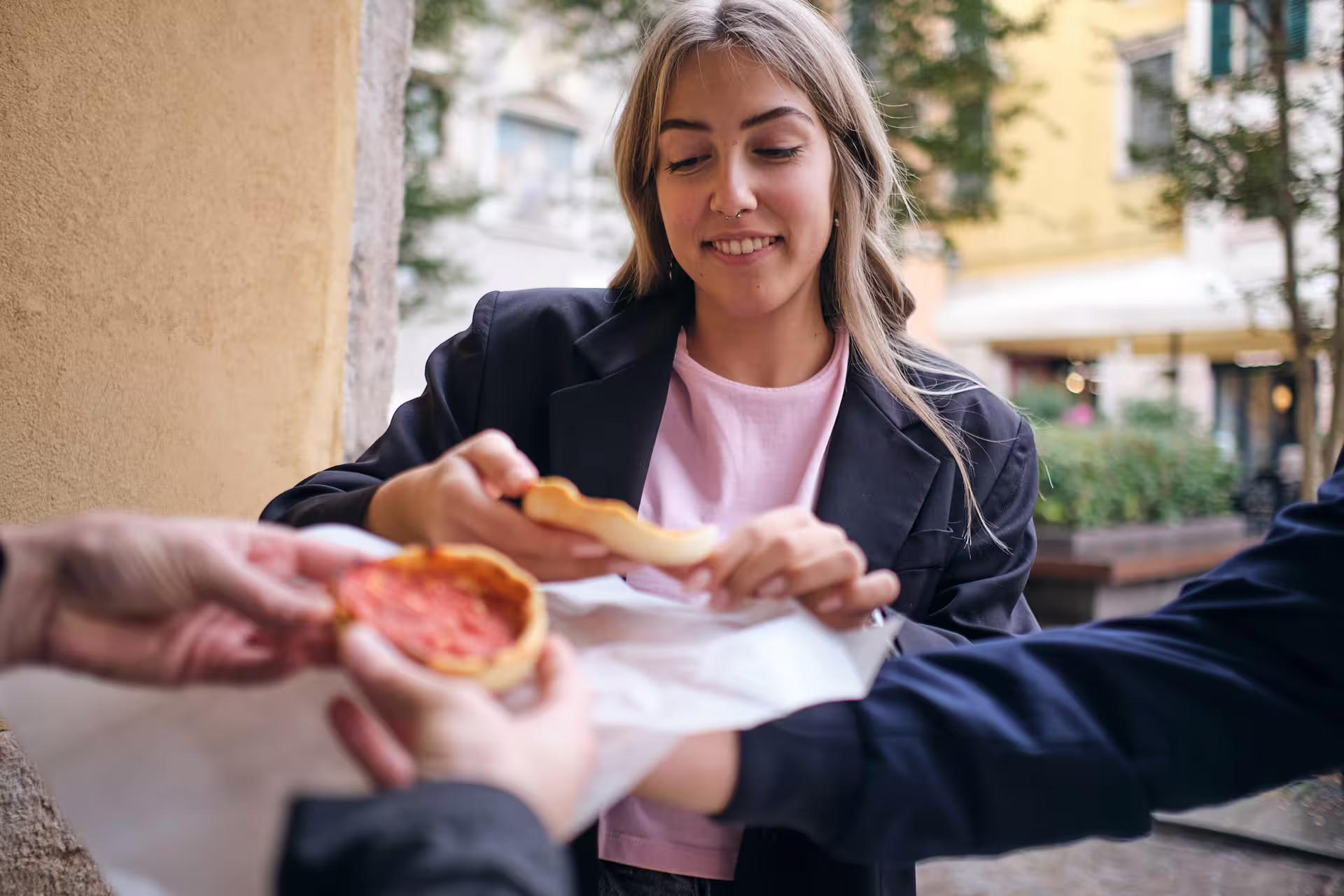 Traveler tasting traditional Veronese street food during 1.5-hour Verona food tour and sightseeing walk