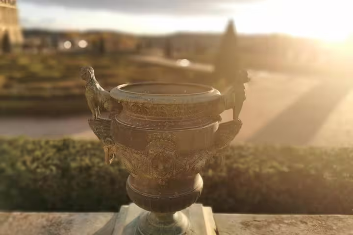 Ornate Versailles garden urn at sunset during a full-day private guided tour with Paris hotel pickup