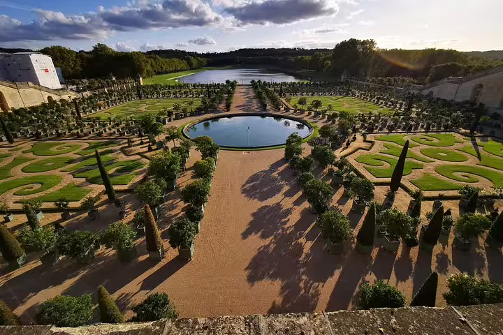 Panoramic view of the Gardens of Versailles and reflecting pool on a full-day private guided tour from Paris