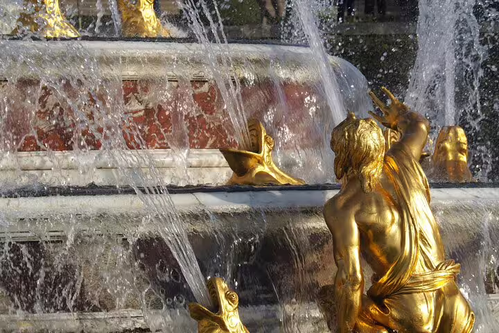 Golden fountain statue with intricate water features at Versailles, highlighted in Paris to Versailles guided tour.