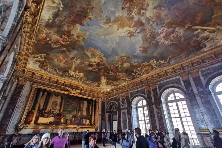 Versailles Palace Hall of Mirrors ceiling frescoes and crowds on guided skip-the-line tour with tickets