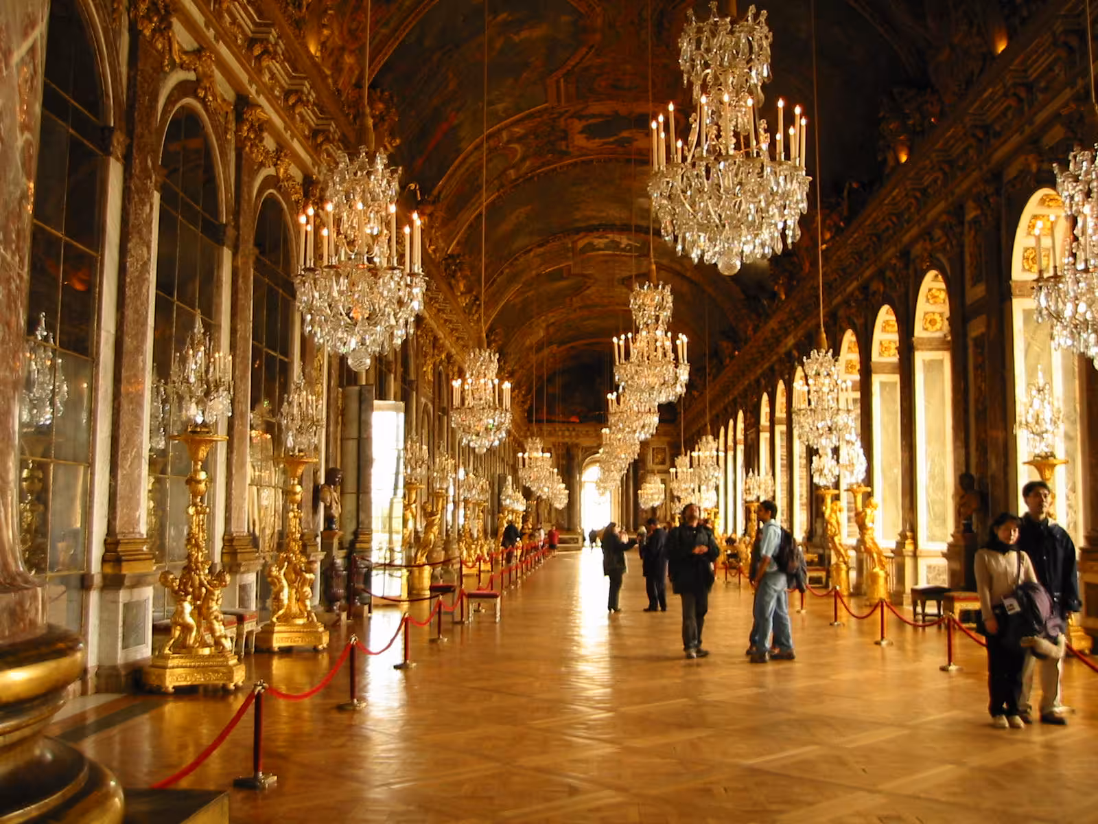 Golden Hall of Mirrors at Versailles Palace with crystal chandeliers on a guided grand tour
