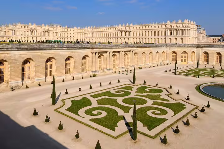 Aerial view of Palace of Versailles ornate French formal gardens with geometric hedge patterns