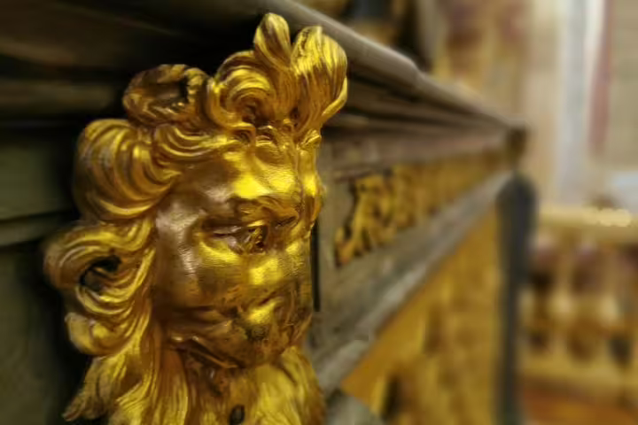 Gilded lion ornament detail inside Versailles Palace, seen on guided tour with skip-the-line tickets