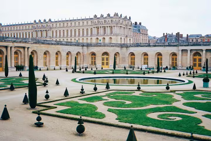 Beautifully manicured gardens at the Palace of Versailles, showcasing French landscaping on a Paris day trip.