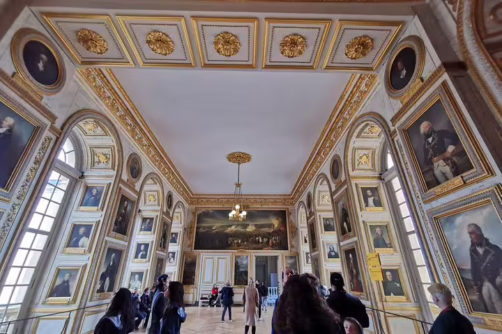 Versailles Palace portrait gallery with gilded ceiling and visitors on guided skip-the-line tour