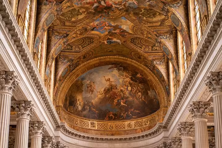Ornate baroque ceiling fresco and gilded arches inside the Royal Chapel at Palace of Versailles