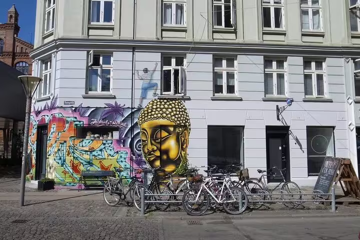 Street art and bicycles in Vesterbro, Copenhagen, showcasing vibrant urban culture on an alternative private tour.