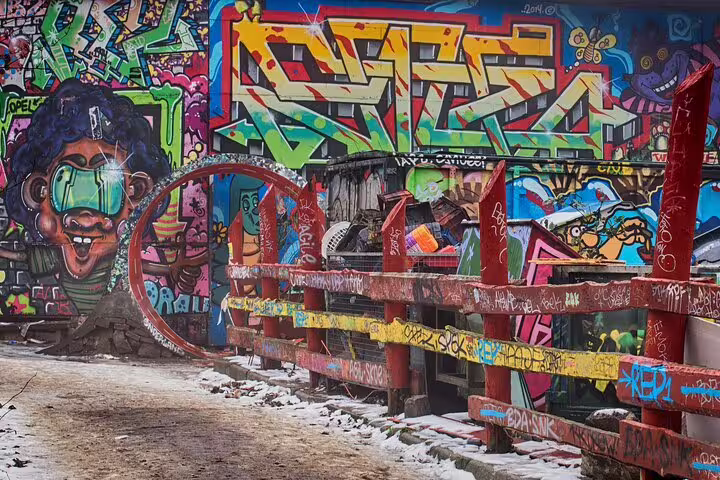 Vibrant street art on a snow-dusted bridge in Vesterbro, Copenhagen, captures the urban flair of this alternative private tour.