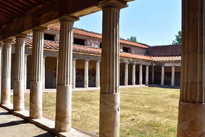 Experience a serene courtyard in Herculaneum with Vesuvius tour, offering skip-the-line entry and easy lunch option.