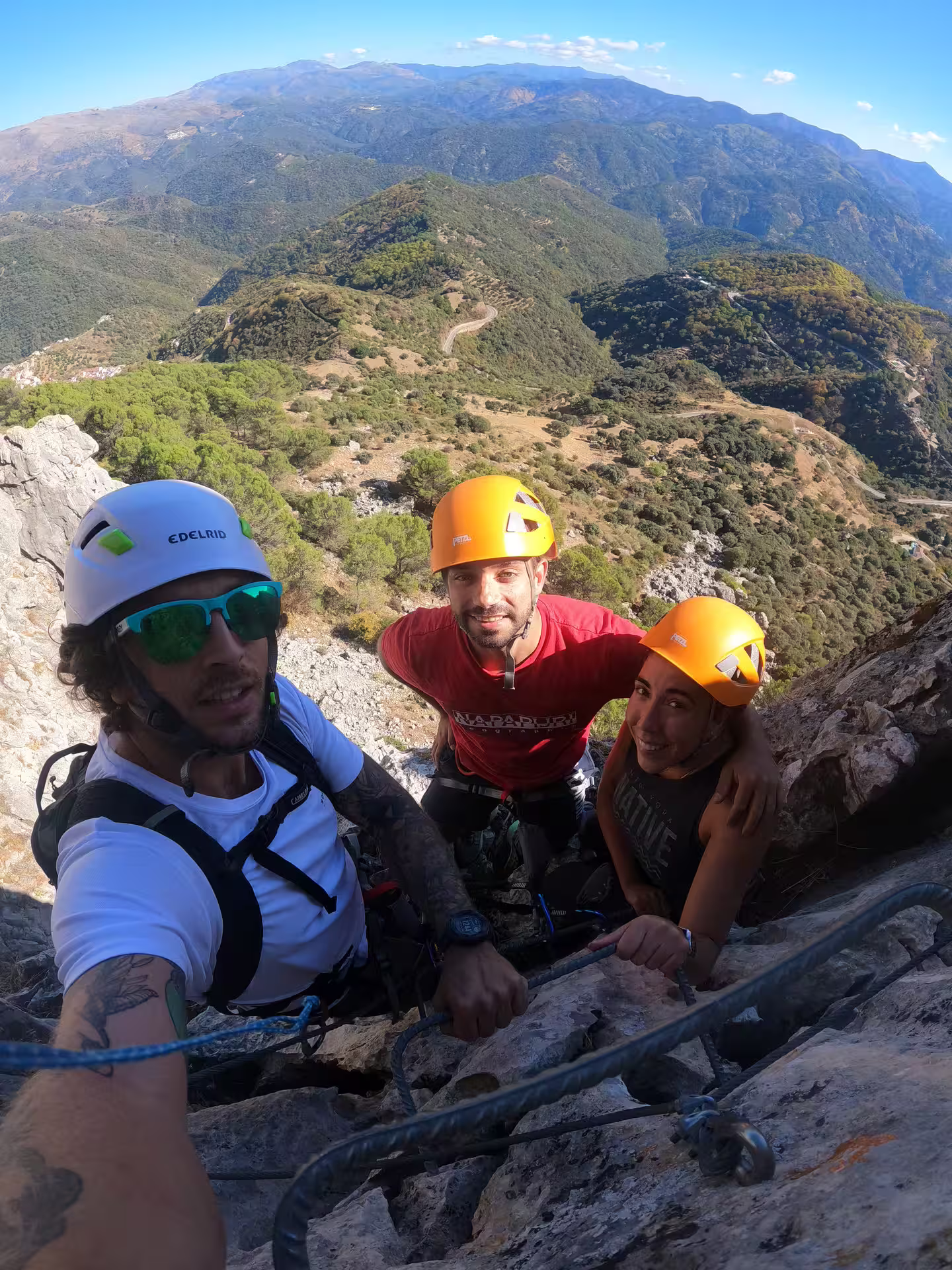 Climbers navigate a challenging vertical route on Via Ferrata Benadalid with stunning views of Costa del Sol's rugged landscape.