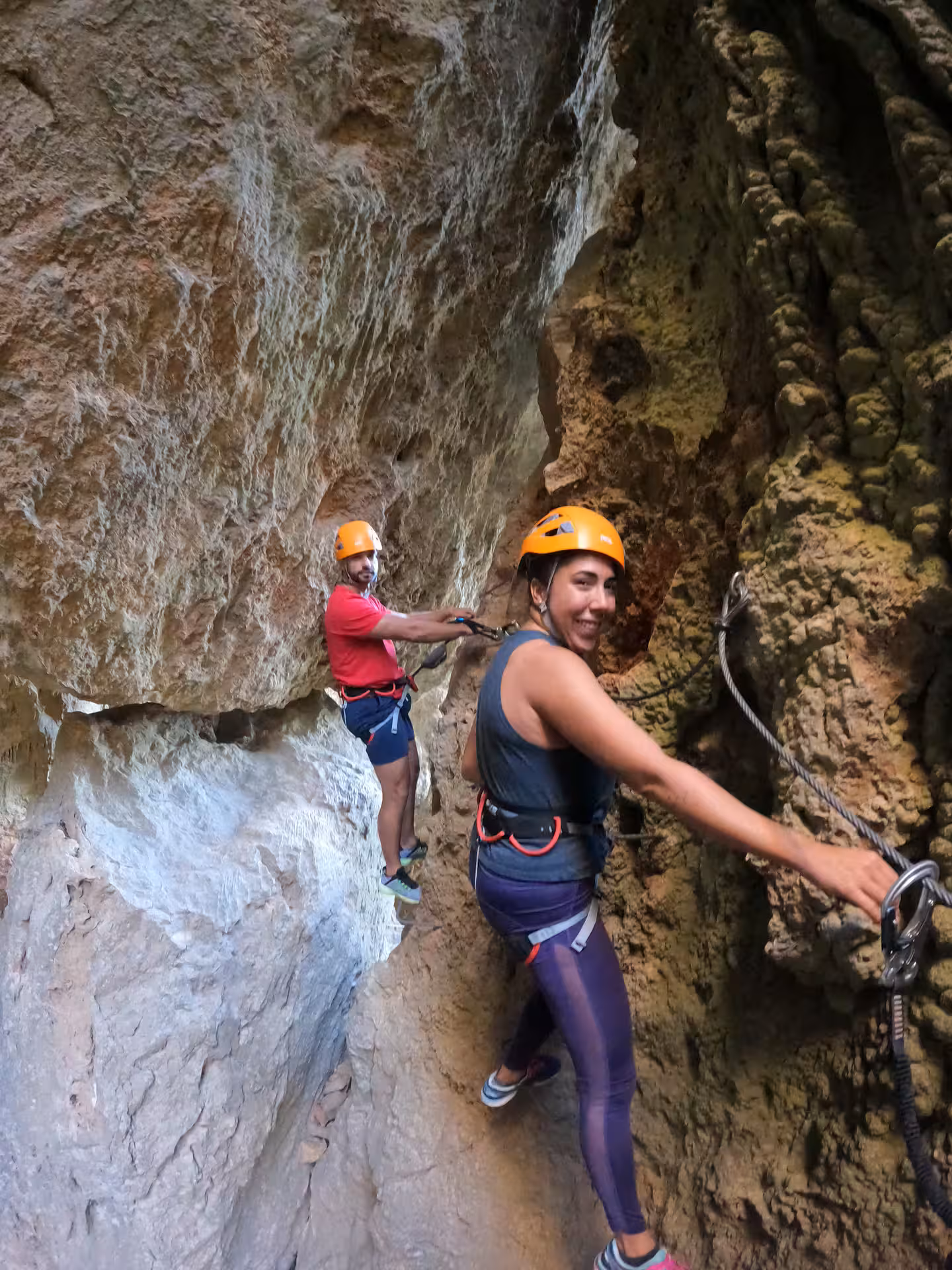 Adventurers enjoy a thrilling Via Ferrata climb in Benalauría, showcasing rugged cliffs and stunning Costa del Sol views.