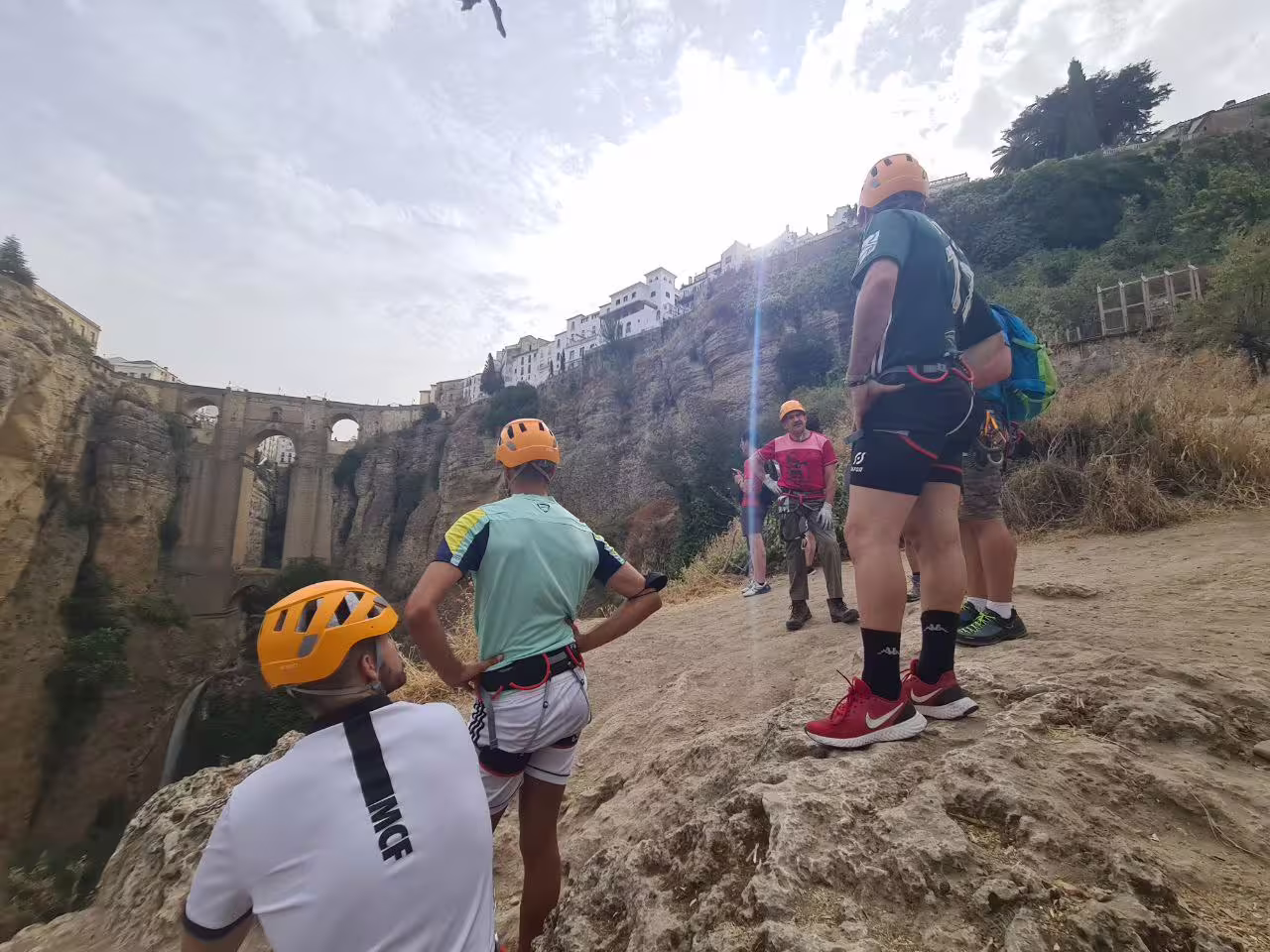 Climbers pause to admire the stunning views near the Tajo de Ronda bridge during their thrilling Via Ferrata tour.