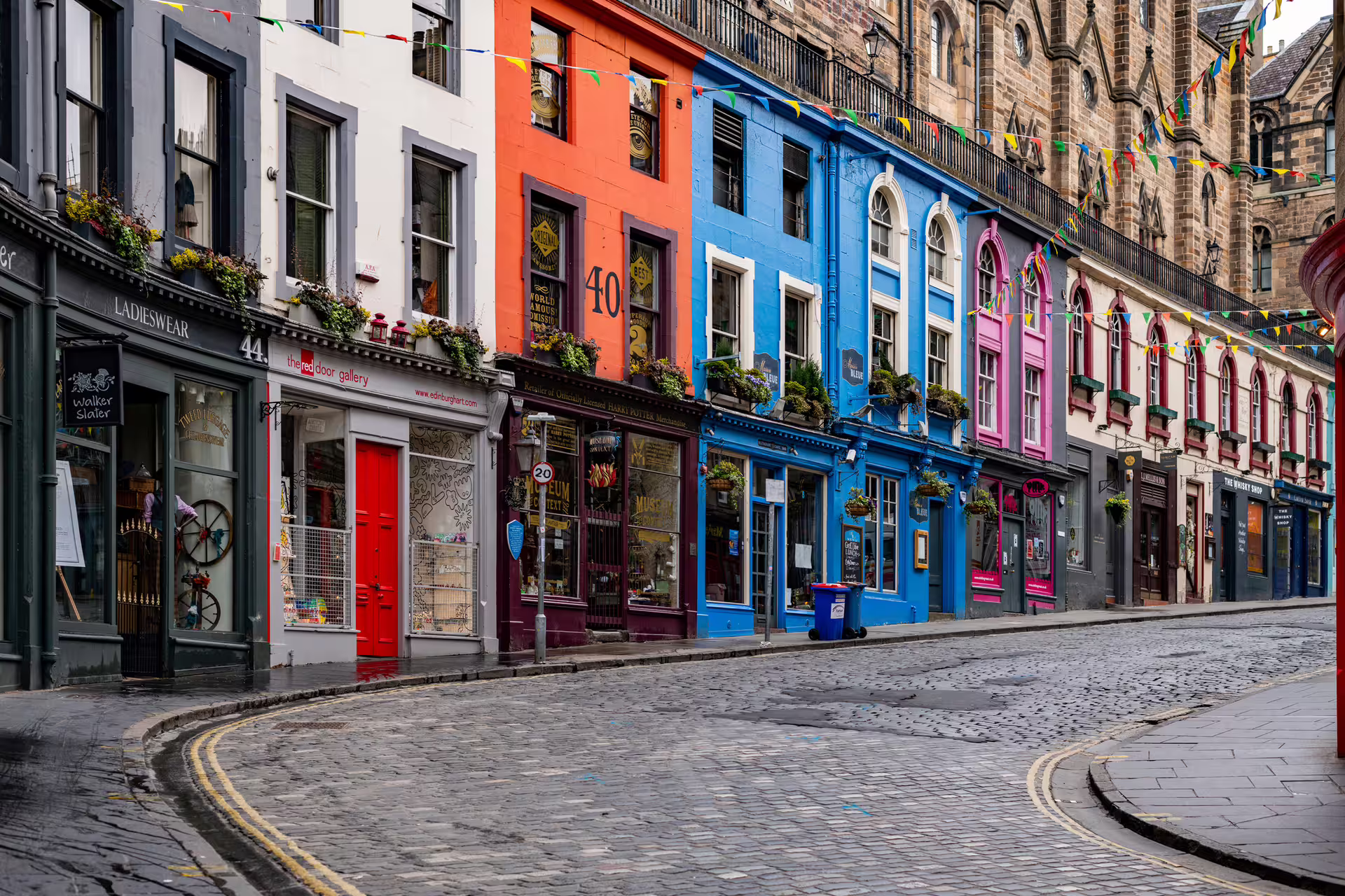 Colorful Victoria Street in Edinburgh Old Town, key stop on 1-day walking tour with multilingual audioguide