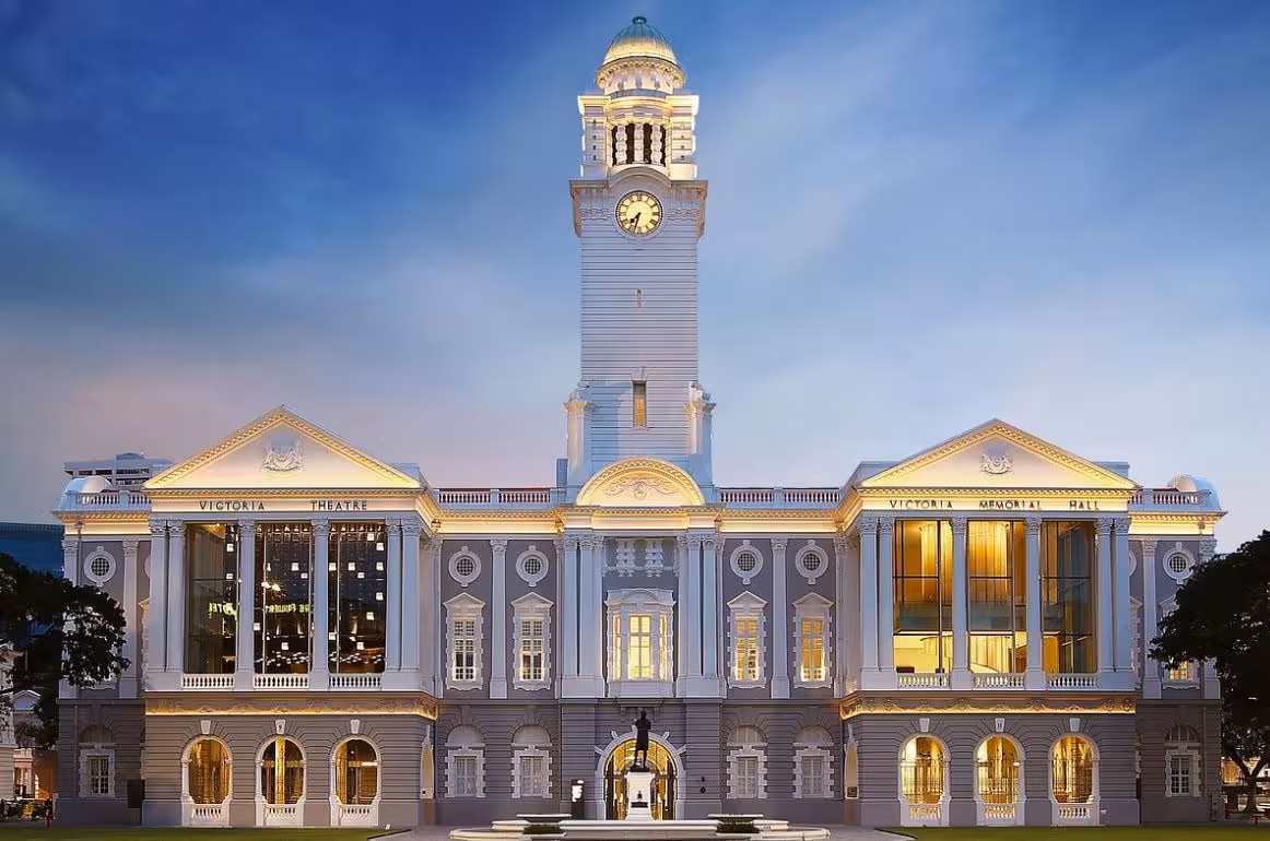 Night view of Victoria Theatre and Concert Hall in Singapore, highlighting its stunning colonial architecture and clock tower.